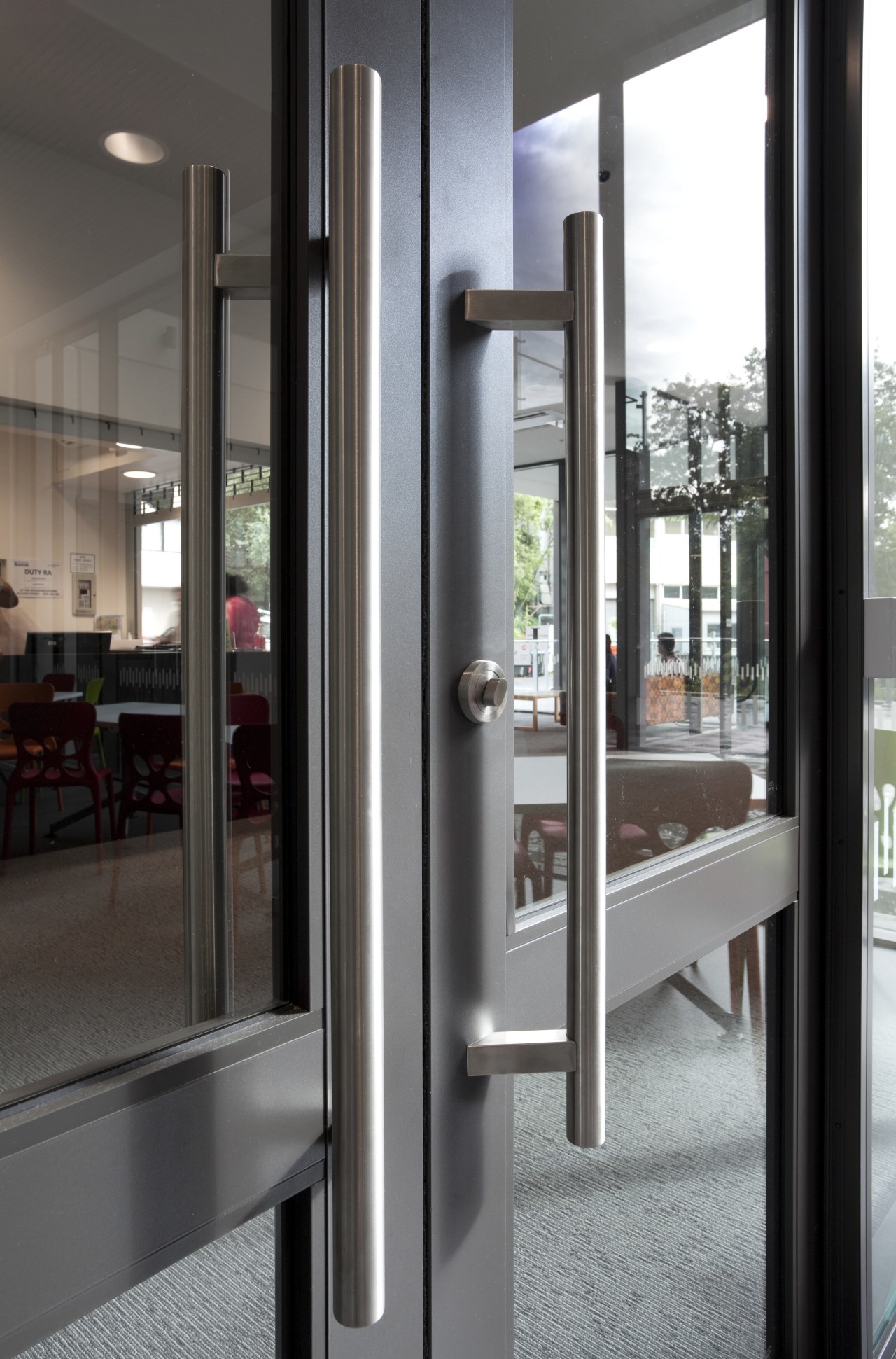 View of door handle. door, structure, gray, black