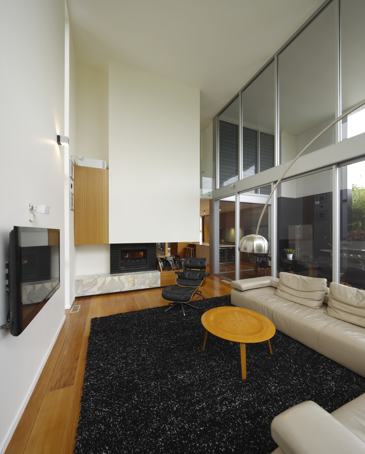 Lounge area with dark floor matt, small wooden architecture, floor, flooring, house, interior design, living room, real estate, room, gray, black