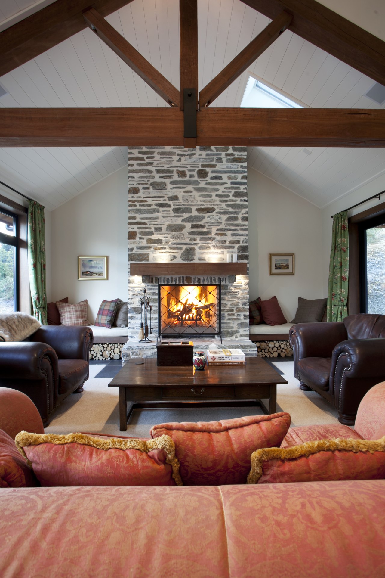 Lounge with exposed ceiling beams, stone chimney and ceiling, fireplace, hearth, home, interior design, living room, real estate, room, red, gray
