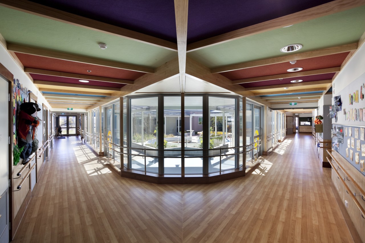 View of forked hallways with wooden flooring. ceiling, daylighting, floor, flooring, interior design, lobby, real estate, brown, gray