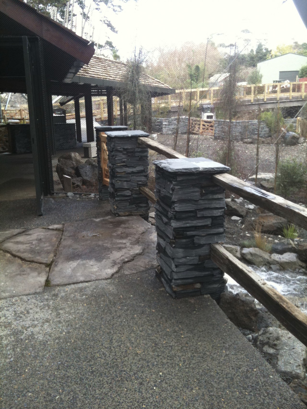 View of stone column. outdoor structure, walkway, wall, gray, black