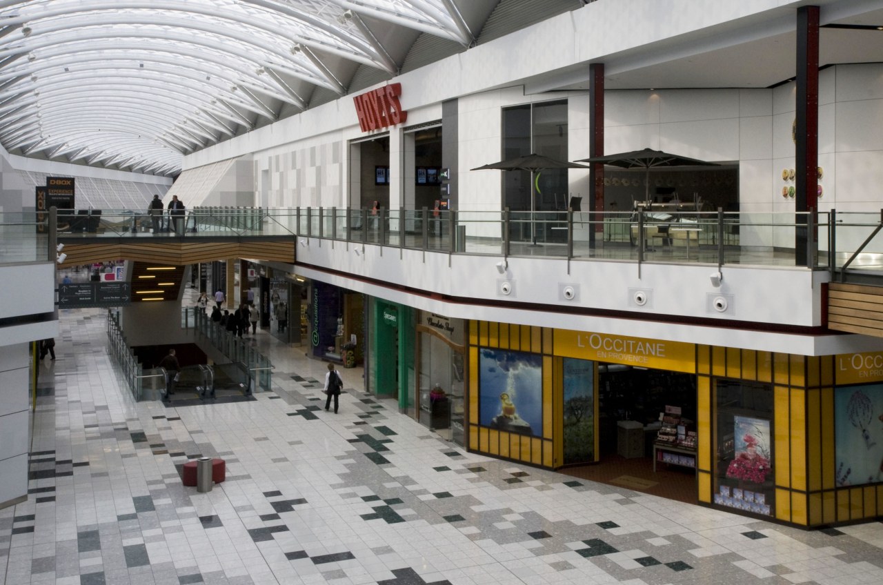 Interior view of multi level mall. building, shopping mall, gray