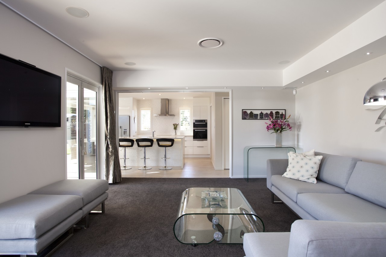 Lounge with dark carpeting, grey couches and glass apartment, architecture, ceiling, home, interior design, living room, property, real estate, room, gray