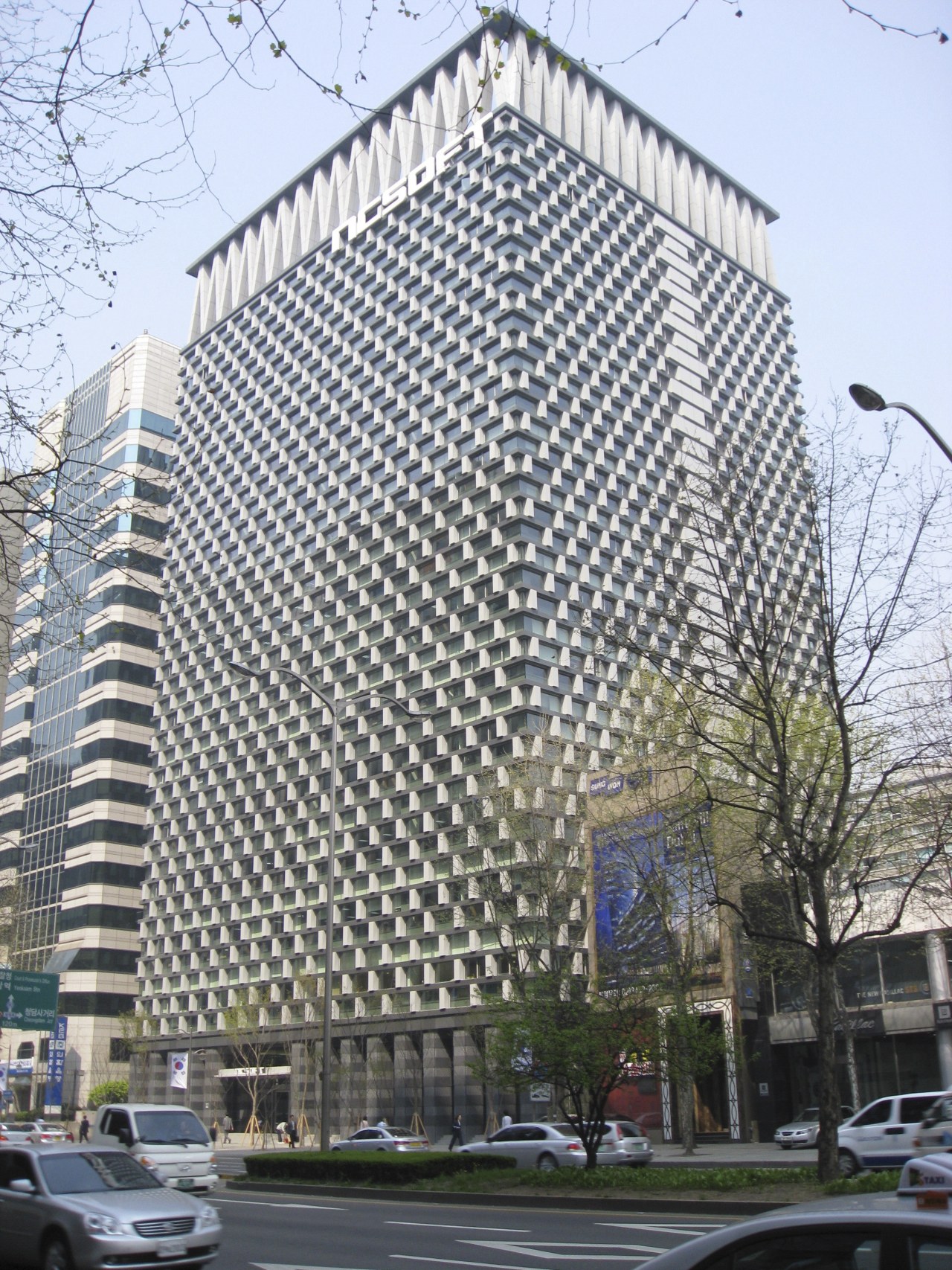 Exterior of office building. architecture, building, city, commercial building, condominium, corporate headquarters, daytime, downtown, facade, headquarters, landmark, metropolis, metropolitan area, mixed use, residential area, skyscraper, tower block, white, gray