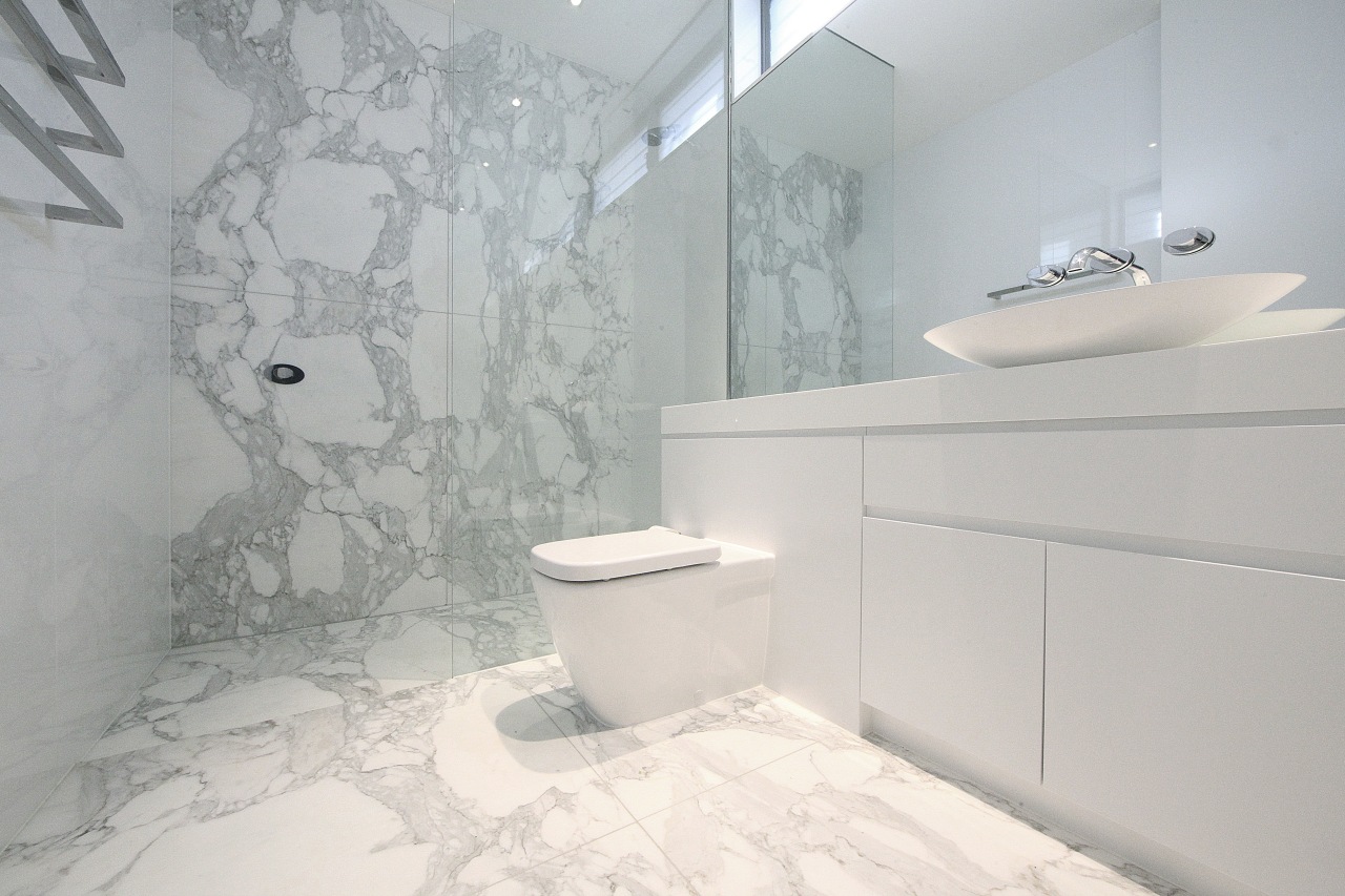 Bathroom with white vanity and toilet and marble bathroom, bidet, ceramic, floor, home, interior design, plumbing fixture, product design, property, room, tap, tile, toilet seat, wall, gray, white