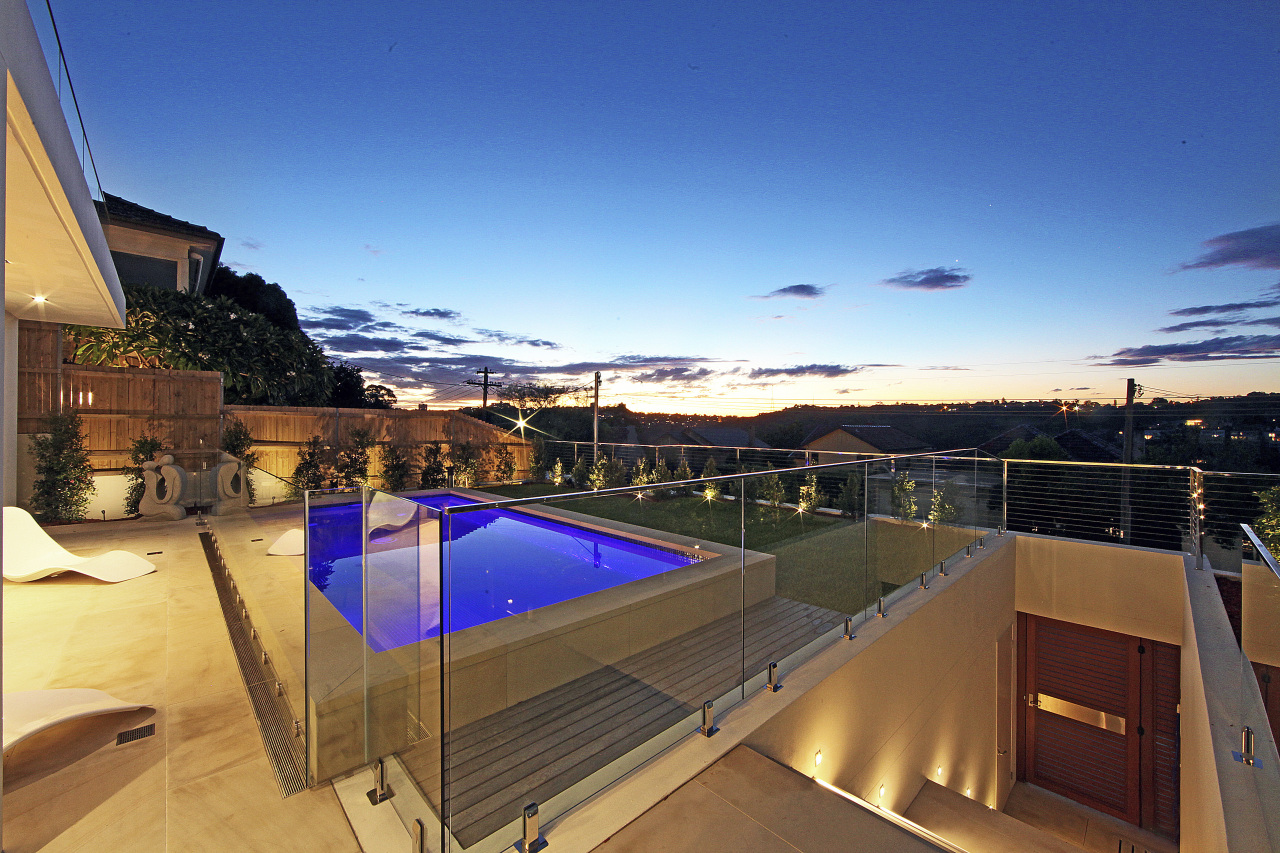 View from balcony to pool at dusk. apartment, architecture, condominium, estate, home, house, penthouse apartment, property, real estate, roof, sky, swimming pool, villa