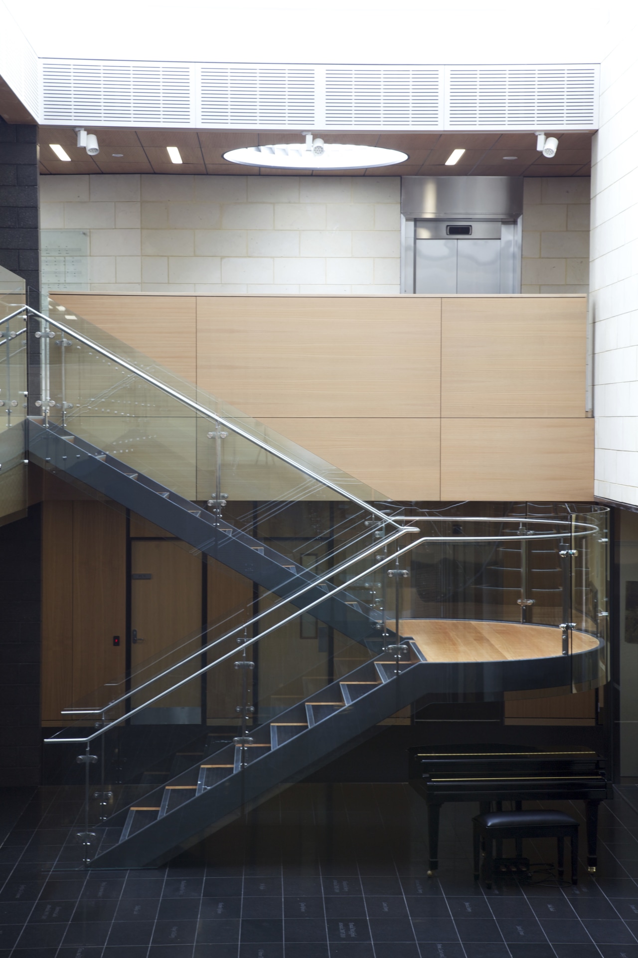 Stairs with wooden wall and grey tiled flooring. architecture, building, daylighting, glass, handrail, line, stairs, steel, structure, black, white