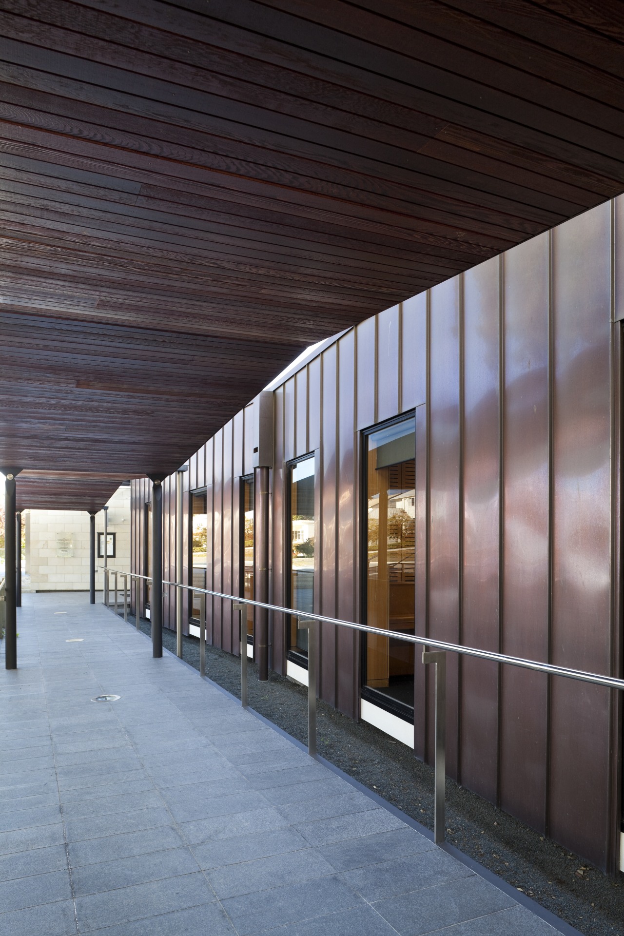 Exterior with red cladding and path. architecture, building, daylighting, facade, structure, window, black, gray