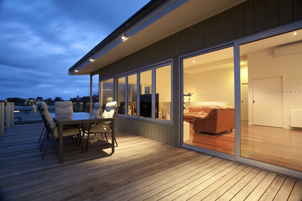 Patio with outdoor furniture. apartment, architecture, deck, hardwood, home, house, interior design, real estate, roof, window, wood, orange