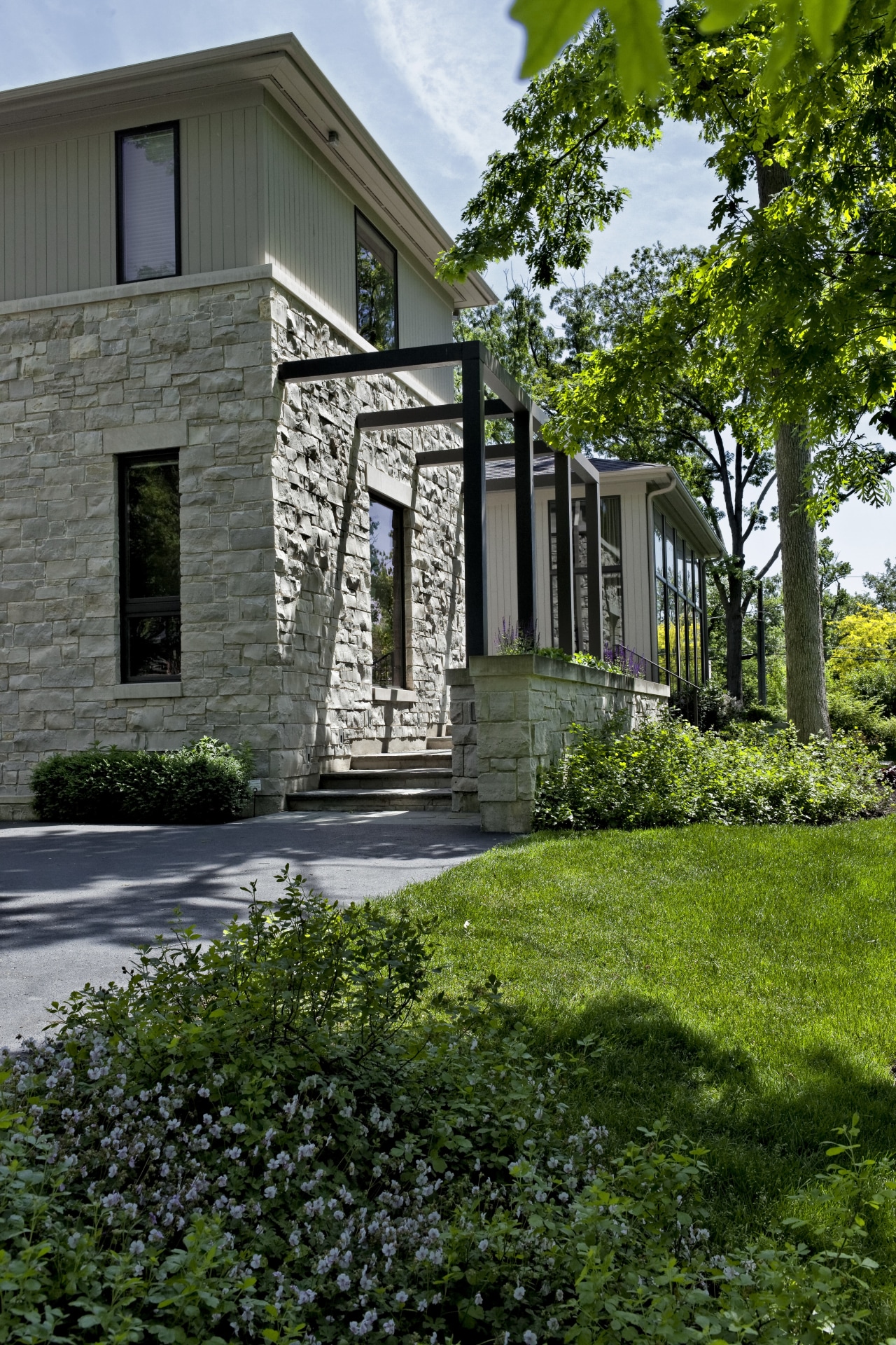 stone outside with paving and lawn architecture, building, cottage, estate, facade, farmhouse, home, house, landscaping, neighbourhood, outdoor structure, property, real estate, residential area, siding, walkway, window, yard, green