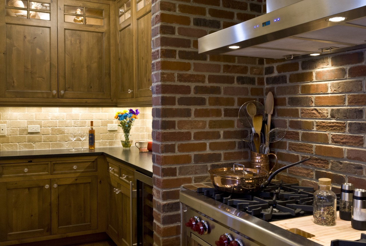 Seen here is the kitchen of the home cabinetry, countertop, flooring, hardwood, interior design, kitchen, room, tile, under cabinet lighting, wood, brown