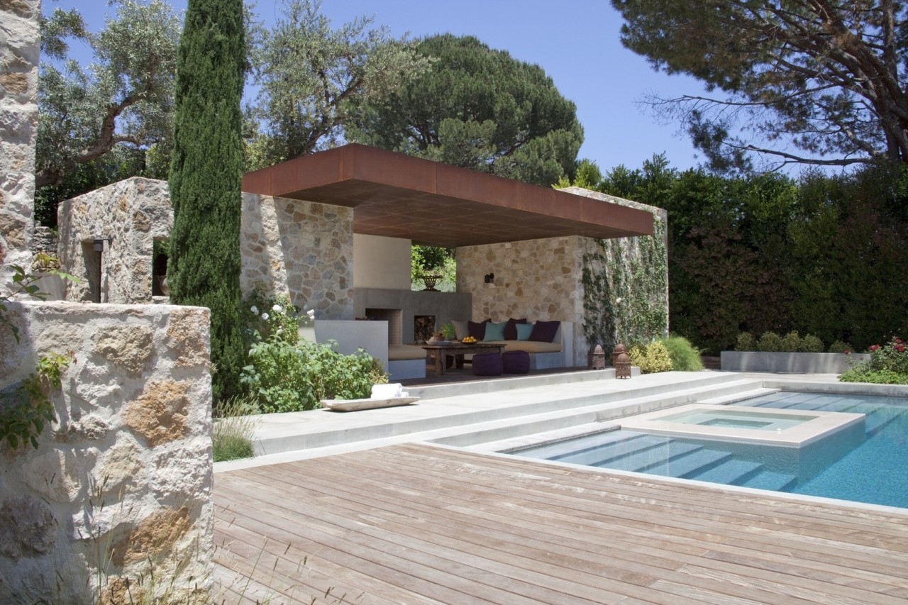 View of the patio area and pool.  backyard, estate, home, house, outdoor structure, property, real estate, villa, gray