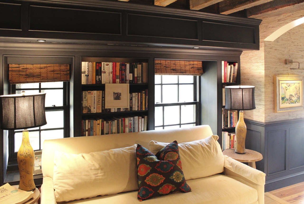 The kitchen in this home was designed by bookcase, ceiling, furniture, home, interior design, living room, room, shelving, wall, window, wood, black, orange