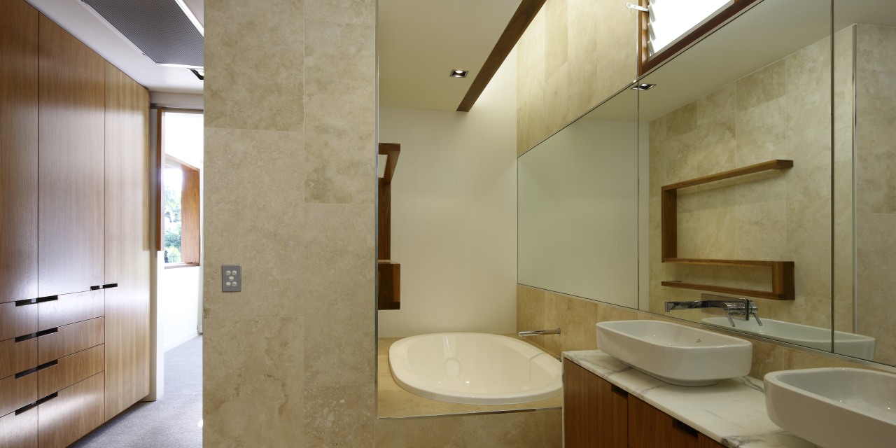 A picture of travertine tile, mirror and warm architecture, bathroom, daylighting, home, interior design, real estate, room, brown