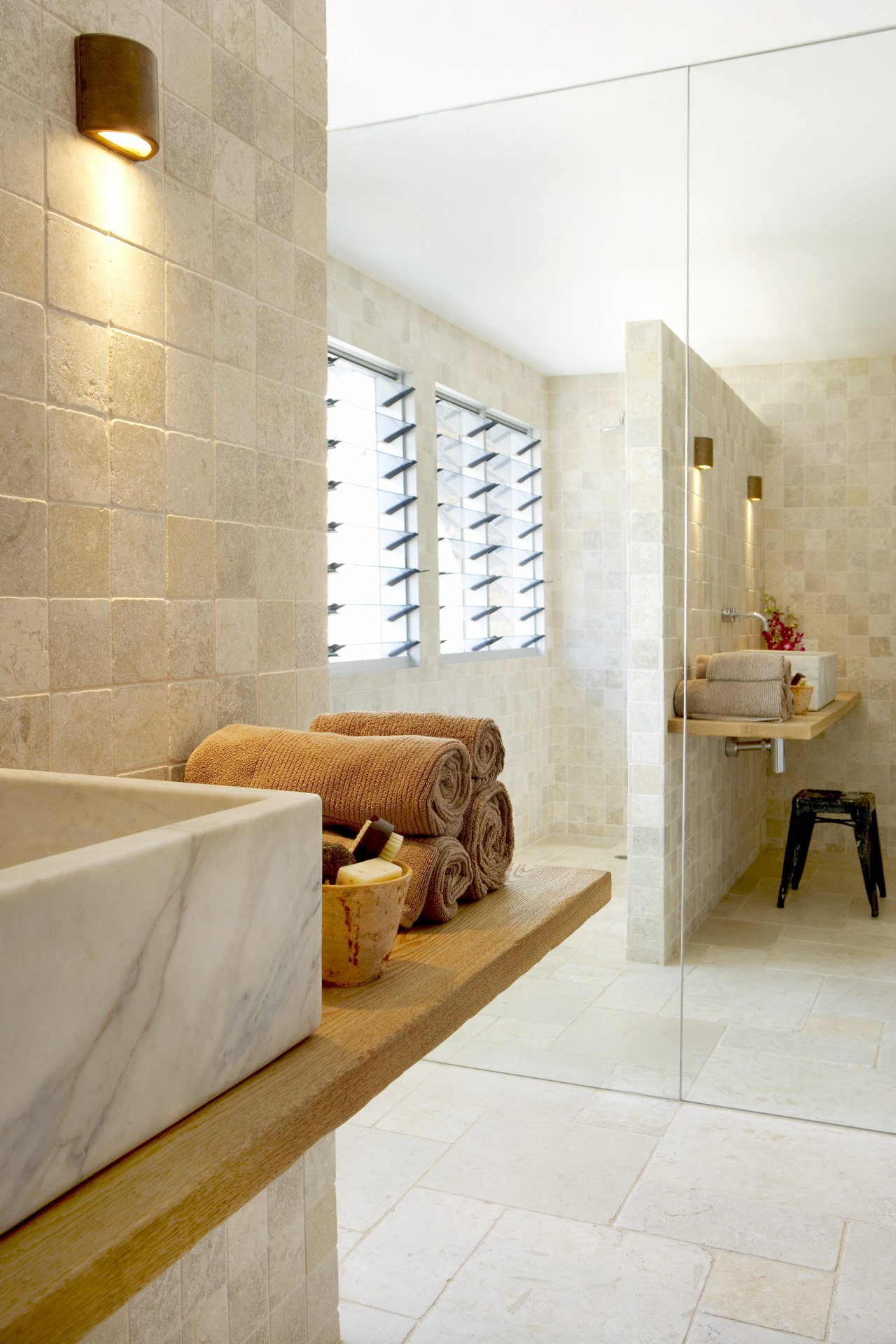 The shower area in this ensuite bathroom has architecture, bathroom, ceramic, floor, flooring, home, interior design, laminate flooring, room, suite, tap, tile, wall, wood, wood flooring, white