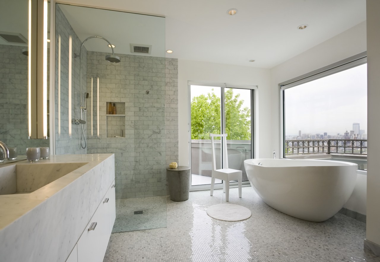 The bathroom is lined with Carrara stone used architecture, bathroom, estate, floor, home, interior design, property, real estate, room, tile, window, gray