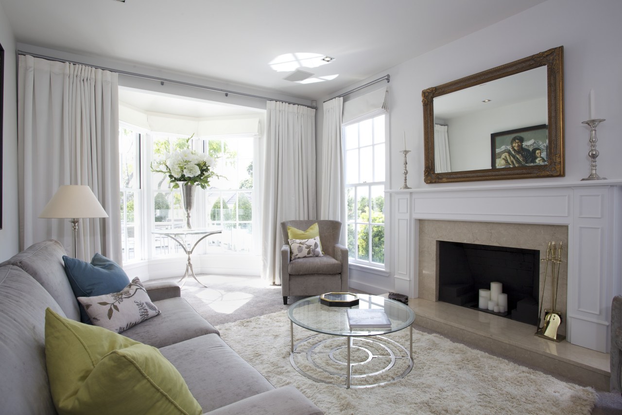 The front living room in this remodeled home ceiling, estate, floor, hearth, home, interior design, living room, property, real estate, room, wall, window, window covering, window treatment, gray