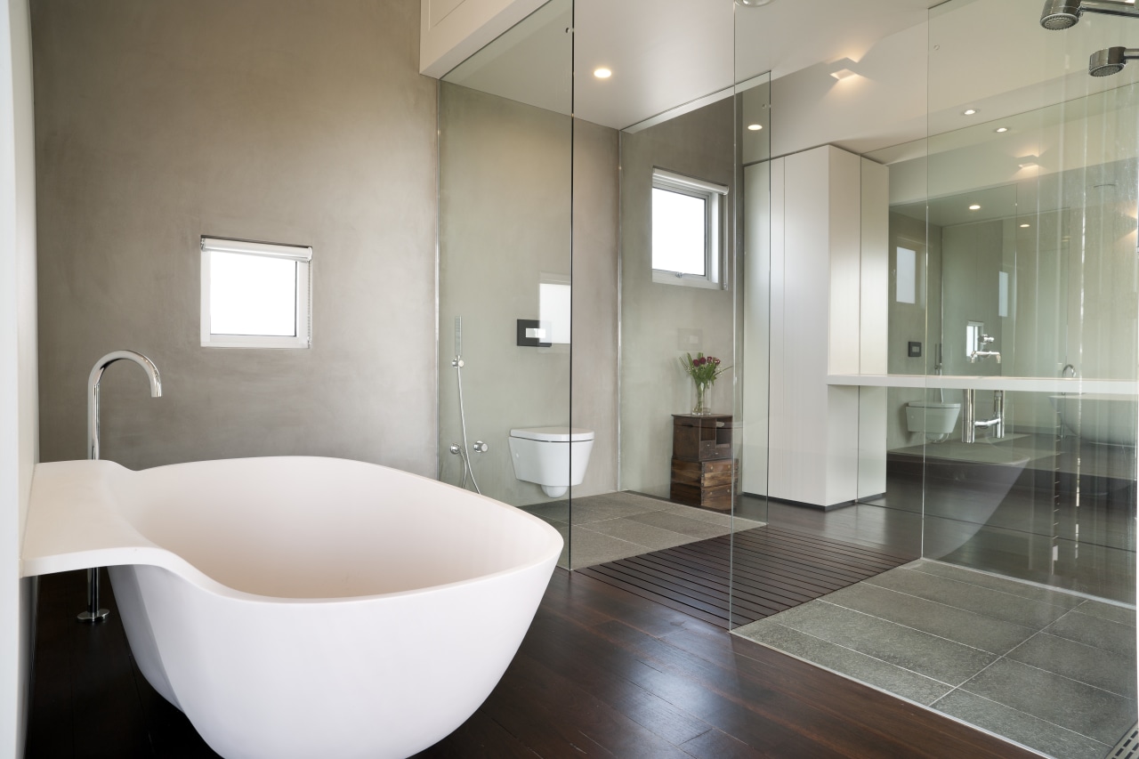 The sleek, custom-designed Minosa stone vanity in this architecture, bathroom, floor, flooring, home, interior design, plumbing fixture, product design, real estate, room, sink, tile, gray