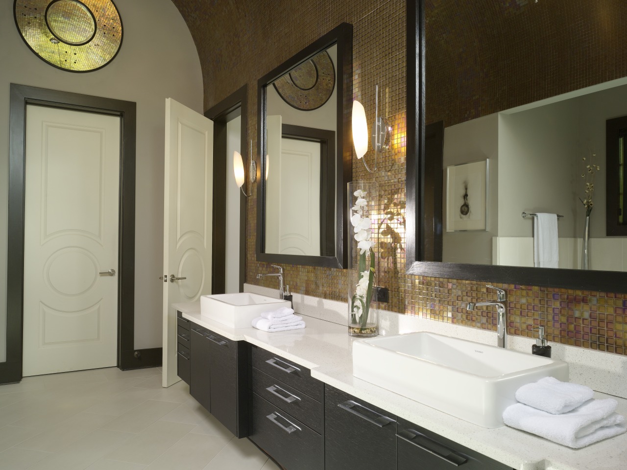 The oversized wall mirrors match the generous scale bathroom, countertop, home, interior design, room, sink, brown, gray