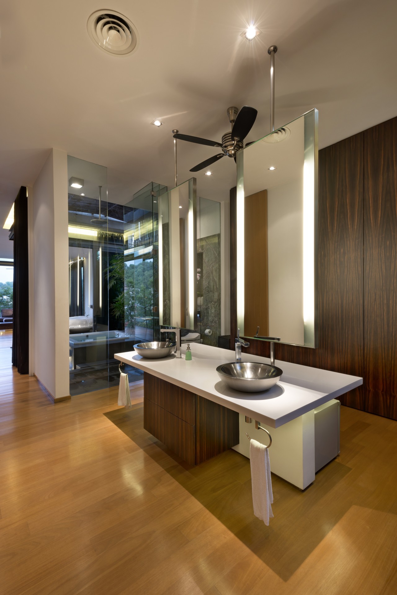 A freestanding, double-sided vanity unit appears suspended within ceiling, countertop, floor, flooring, hardwood, interior design, kitchen, laminate flooring, living room, real estate, room, table, wood flooring, brown