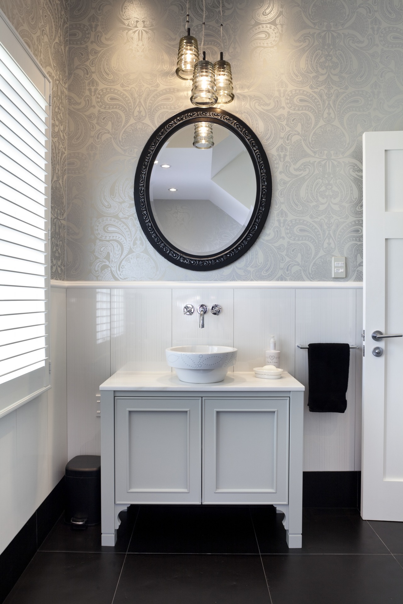 The vanity in the guest bathroom is painted bathroom, bathroom accessory, bathroom cabinet, bathroom sink, floor, flooring, home, interior design, plumbing fixture, product design, room, sink, tap, gray