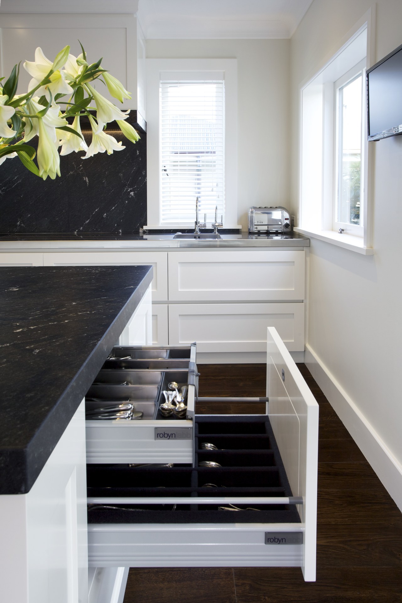 This classic kitchen by Robyn Labb offers modern cabinetry, countertop, floor, furniture, hardwood, home, interior design, kitchen, room, gray