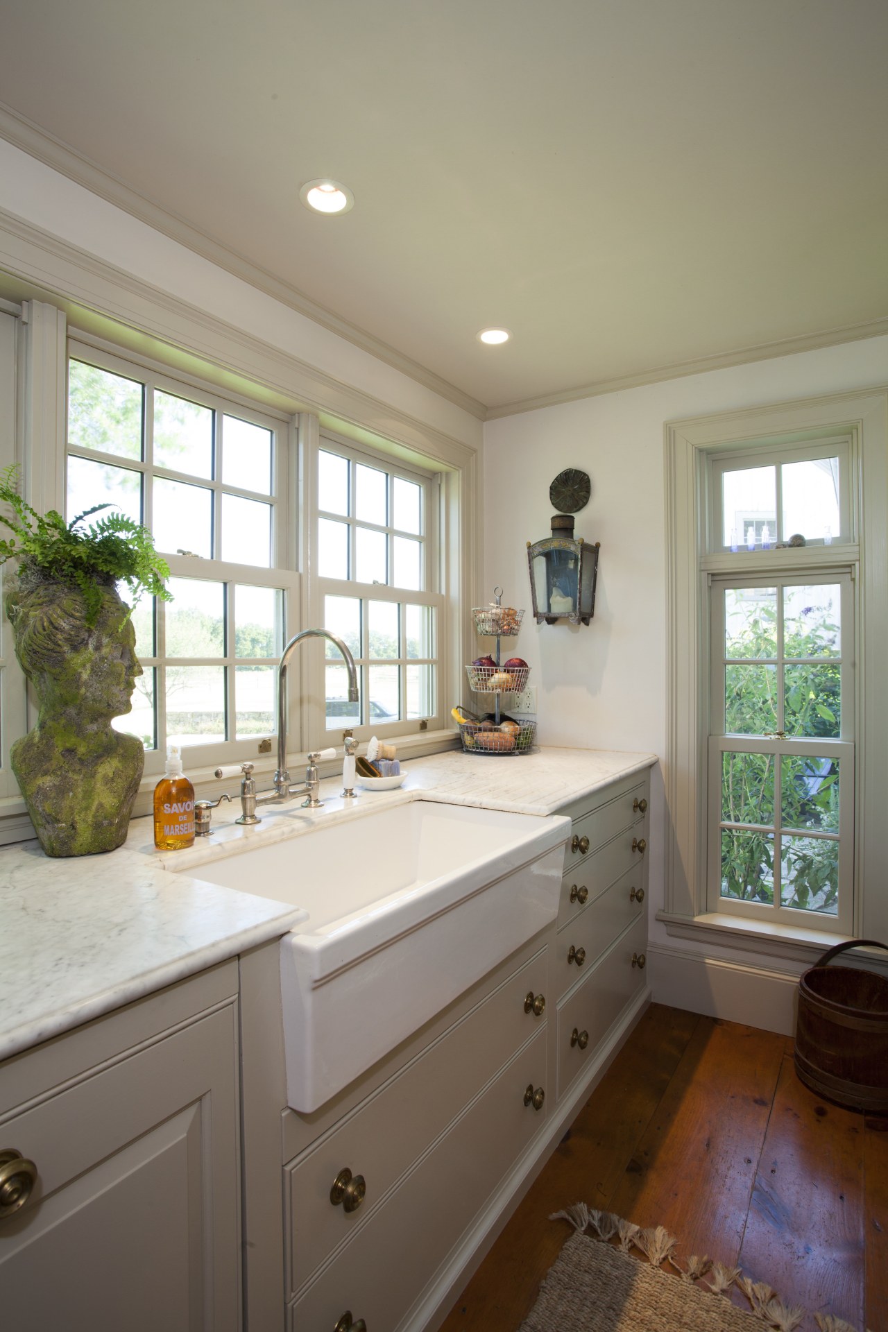 This kitchen blends with its surroundings through architectural cabinetry, countertop, home, house, interior design, kitchen, real estate, room, window, gray, brown