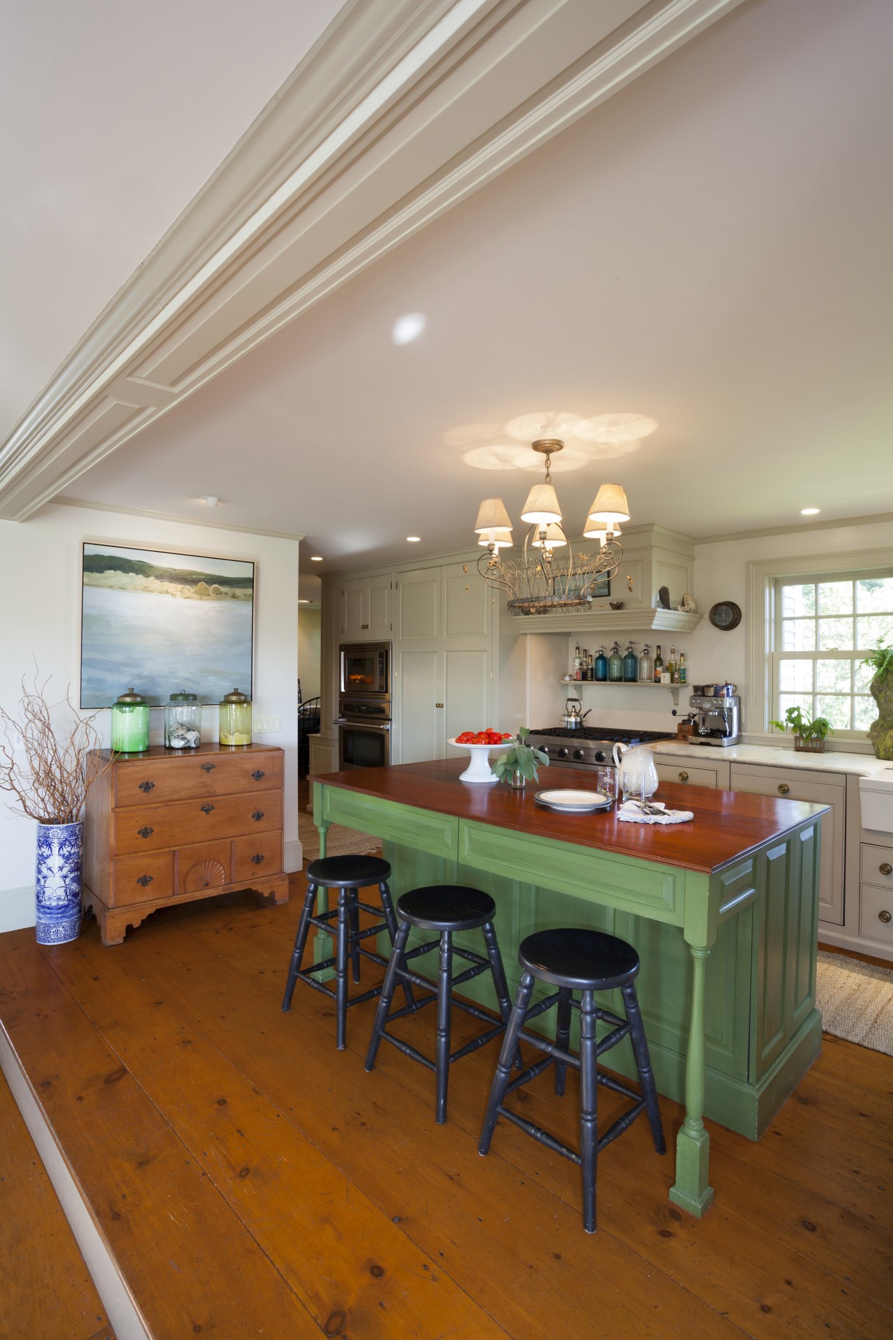 This kitchen blends with its surroundings through architectural ceiling, dining room, floor, flooring, furniture, hardwood, home, house, interior design, kitchen, living room, real estate, room, table, gray, brown