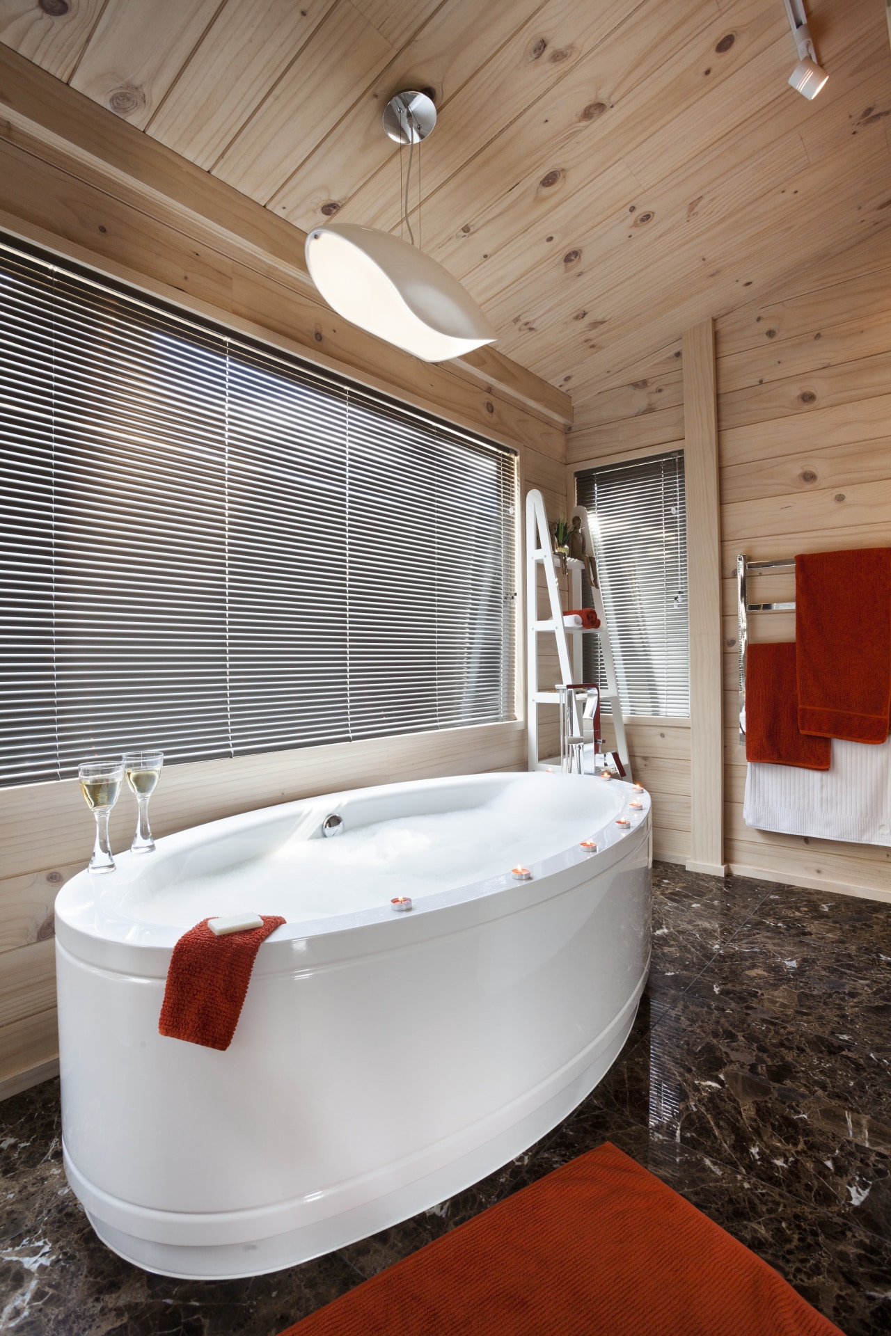 A freestanding tub is a feature of the architecture, floor, flooring, furniture, interior design, room, wood