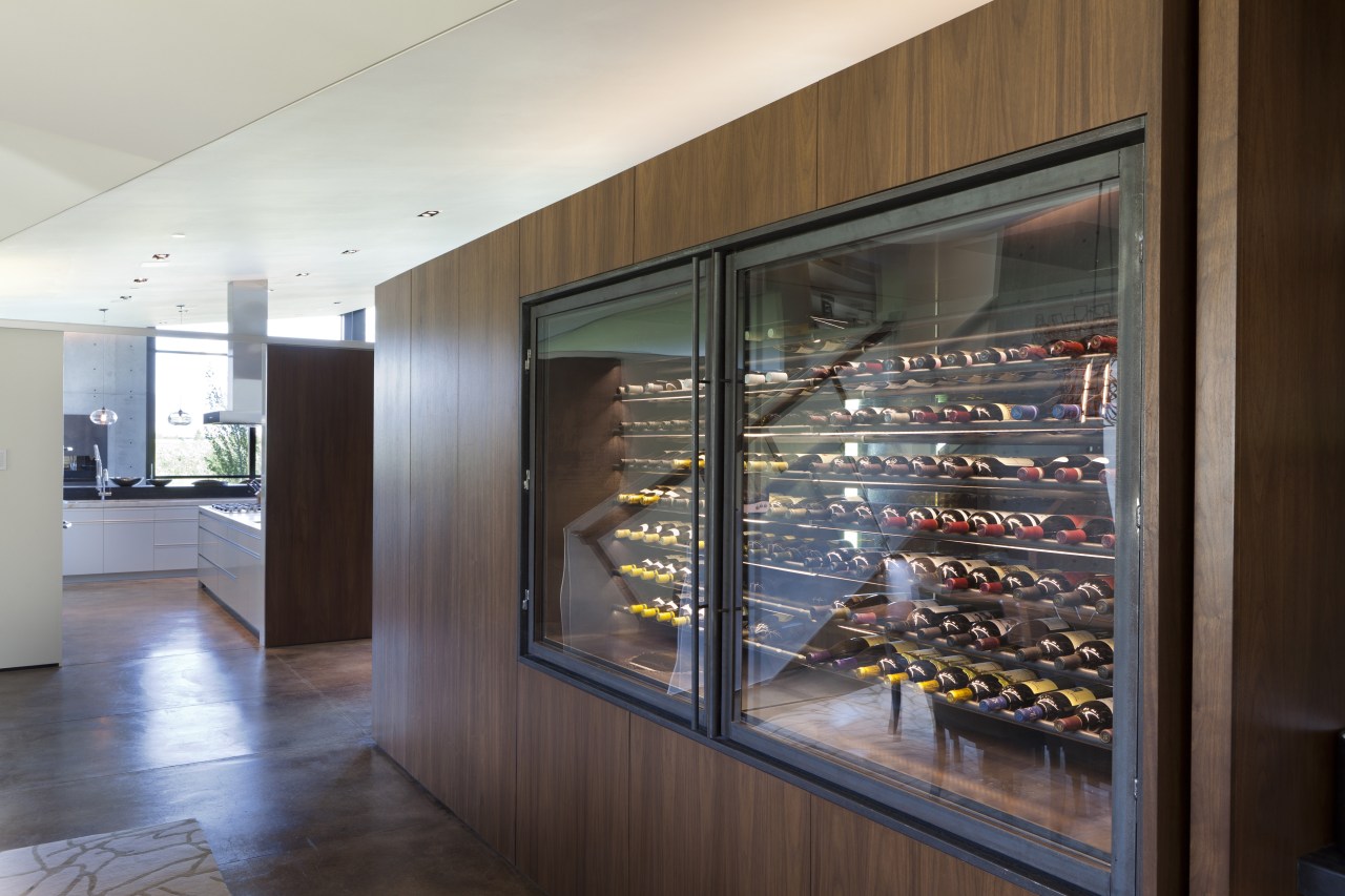 The walnut cabinet which contains a refrigerated wine display case, interior design, gray