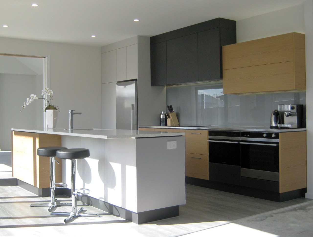 A clean-lined European-style kitchen by Helen Reason of cabinetry, countertop, cuisine classique, furniture, interior design, kitchen, product design, room, gray