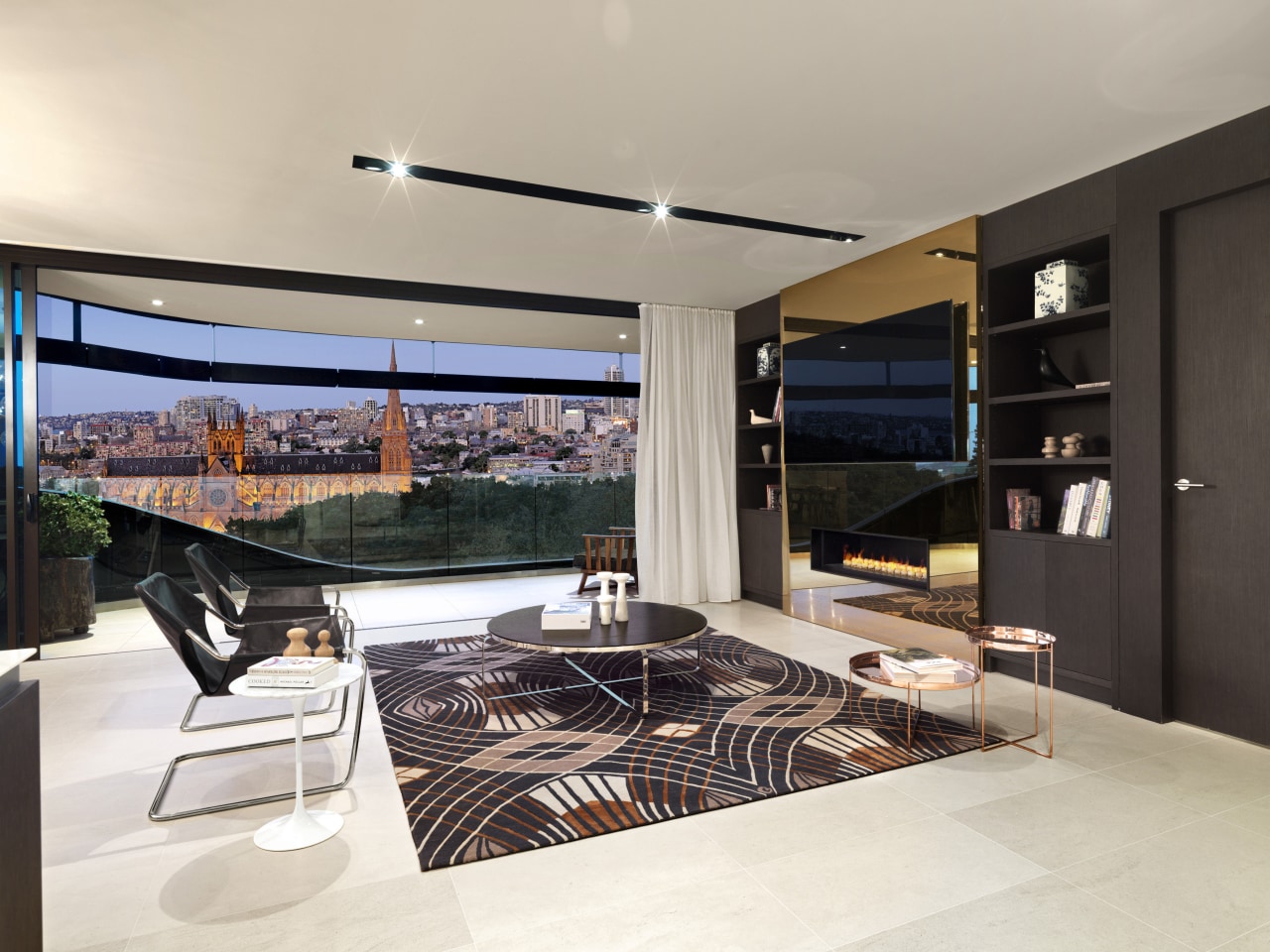 This open-plan contemporary living space in a Sydney interior design, kitchen, gray, black