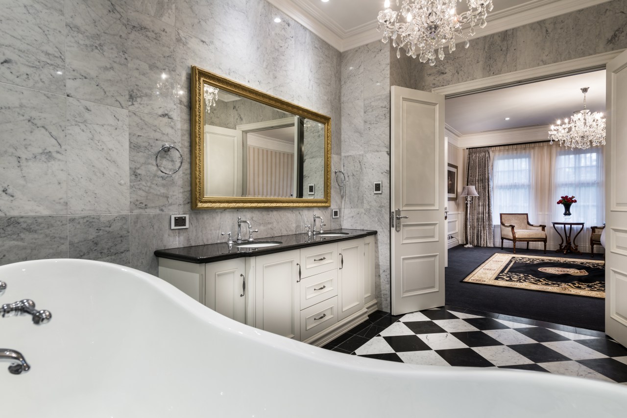 Chandeliers reinforce the glamour of this master suite bathroom, floor, flooring, home, interior design, real estate, room, wall, gray