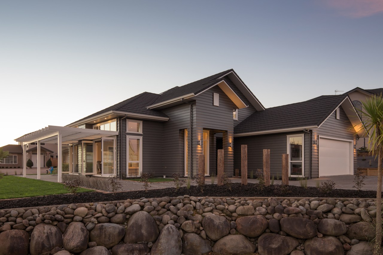 This Landmark Homes family home, clad in James building, cottage, elevation, estate, facade, home, house, landscape, property, real estate, residential area, roof, siding, black, gray