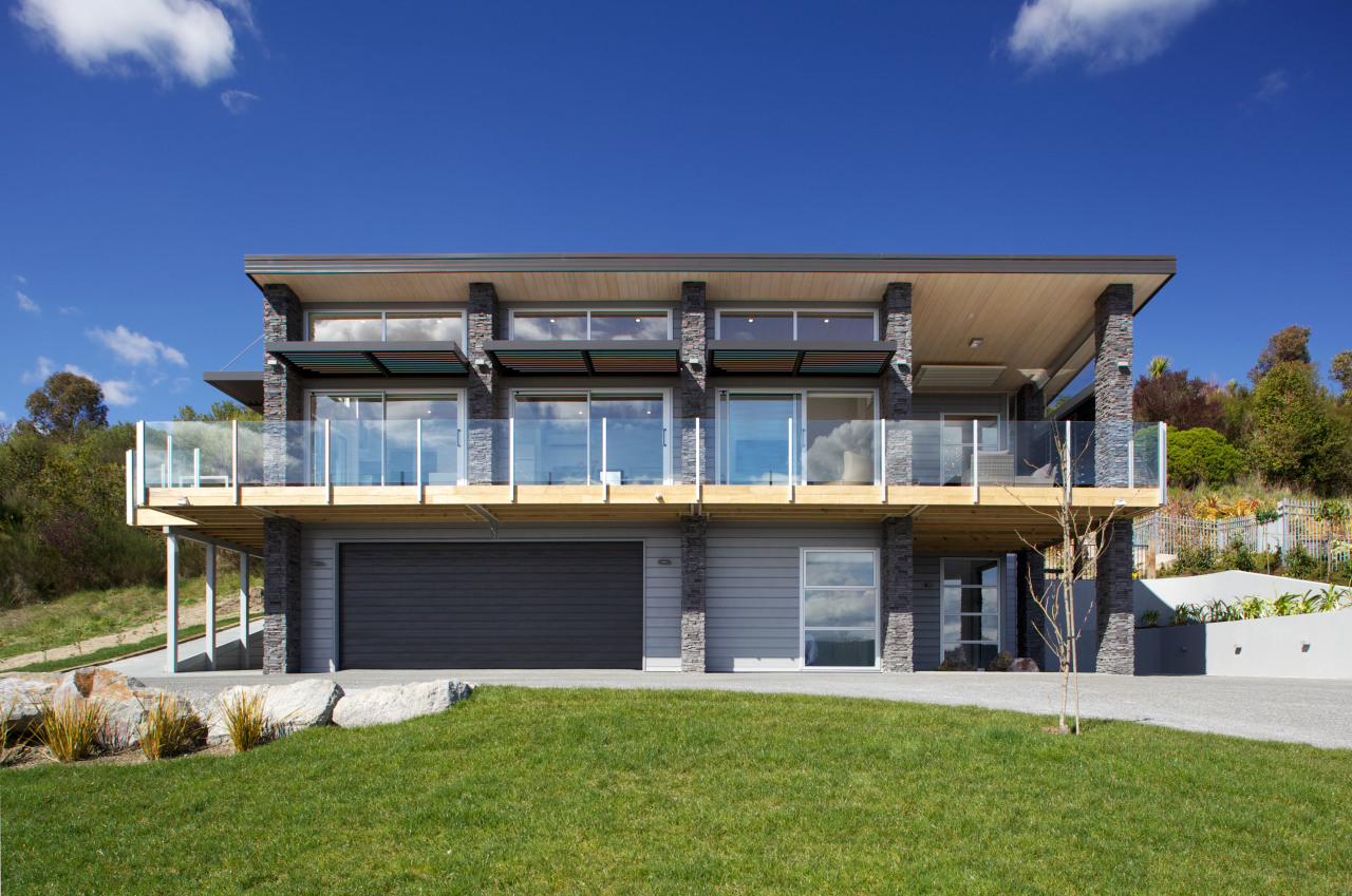 Lockwood Home with schist stone columns, solid blonded architecture, elevation, estate, facade, home, house, property, real estate, residential area, villa, blue