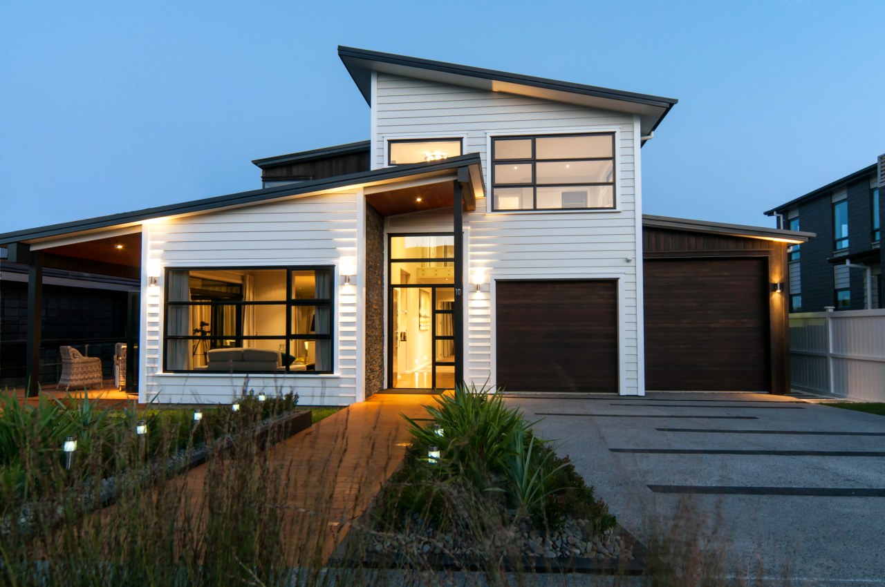 This Shore Homes show home has a strong architecture, building, elevation, facade, home, house, property, real estate, residential area, siding, window, black, teal