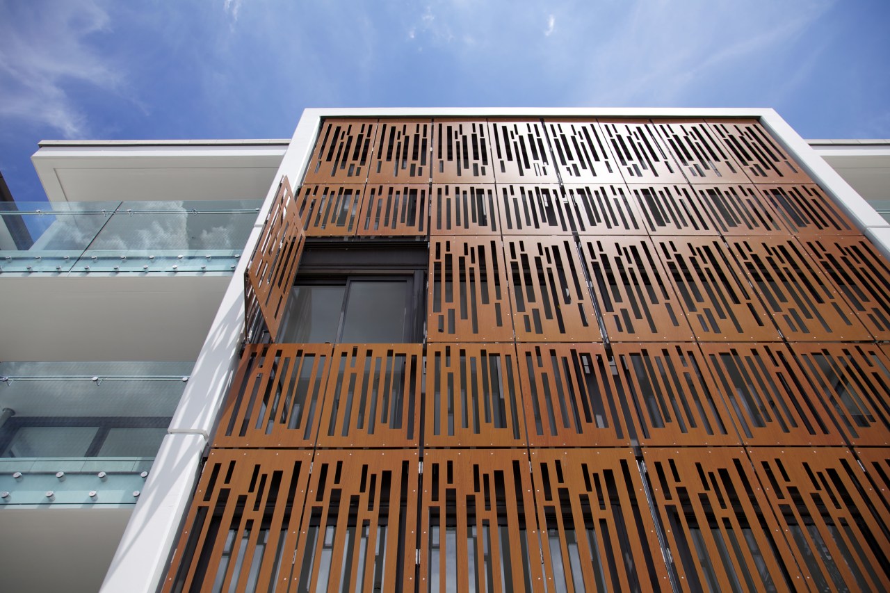 Laser-cut powdercoated aluminium screens on this apartment building architecture, building, commercial building, condominium, daylighting, facade, line, sky, structure, wood