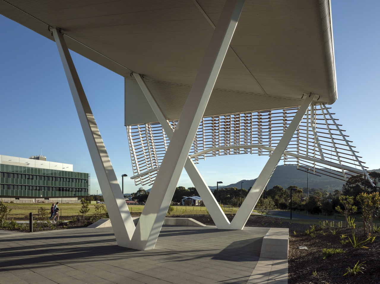 An imposing canopy straddles the main pedestrian spine architecture, bridge, cable stayed bridge, concrete bridge, daylighting, extradosed bridge, fixed link, girder bridge, landmark, overpass, sky, skyway, structure, black, teal