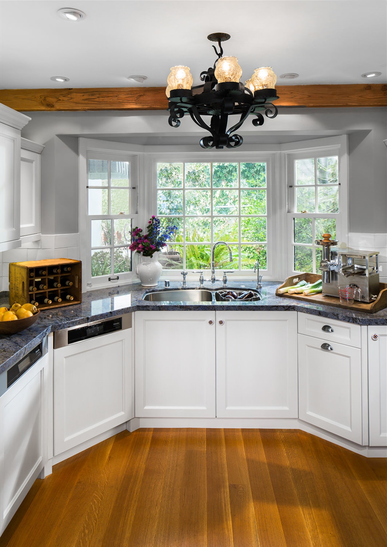 A bay window at one end of this cabinetry, countertop, cuisine classique, interior design, kitchen, room, window, gray