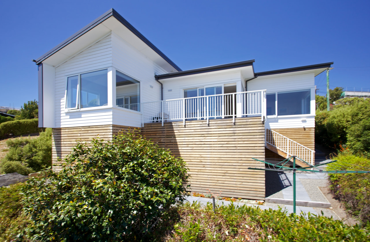 This new Christchurch house features Palliside low-maintenance weatherboards cottage, elevation, estate, facade, home, house, property, real estate, residential area, siding, sky, villa, window, blue