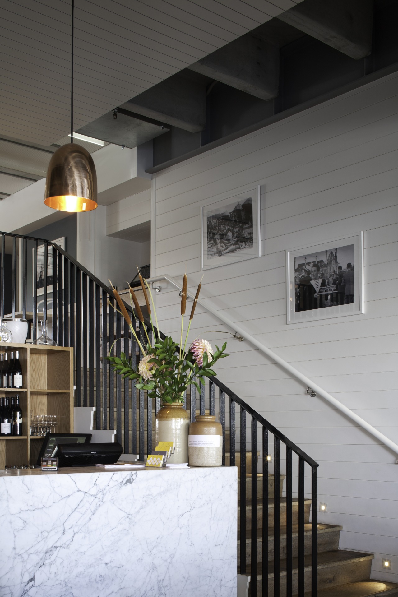 A Carrara marble counter draws on customary French apartment, architecture, building, facade, handrail, home, house, interior design, lobby, loft, stairs, wall, window, gray