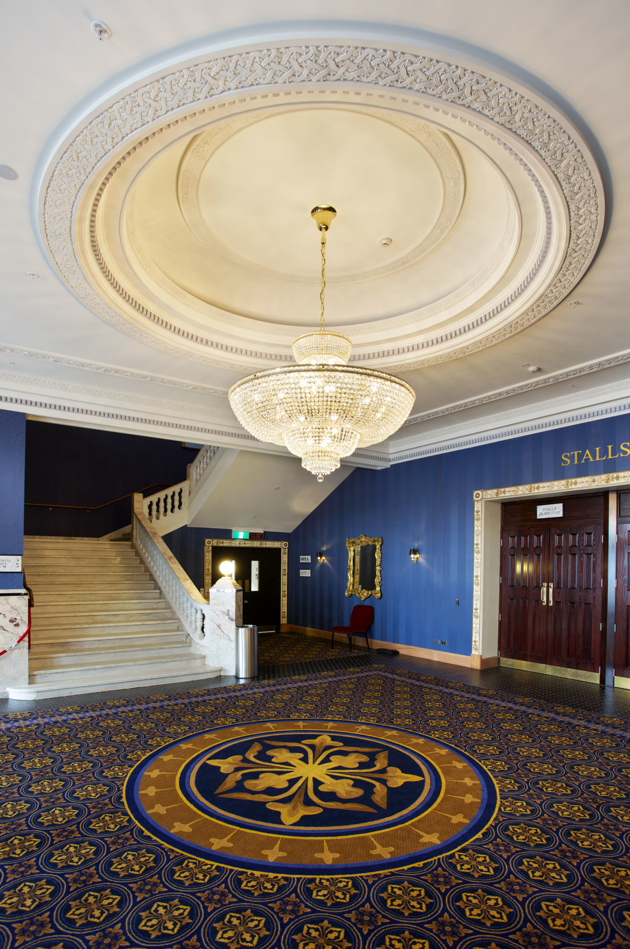 :Custom chandeliers at the Isaac Theatre Royal were architecture, ceiling, column, daylighting, estate, floor, flooring, interior design, lobby, structure, symmetry, wall, gray