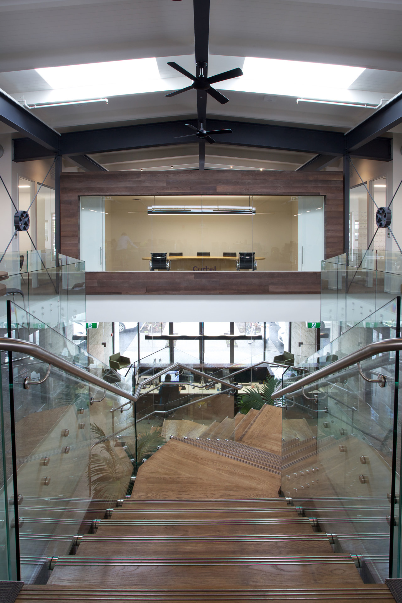 A twisting central staircase provides a dramatic centrepiece daylighting, floor, flooring, glass, interior design, wood, gray