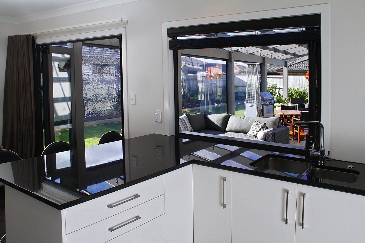 In this house by Fowler Homes Manawatu landscaped home appliance, kitchen, window, gray, black