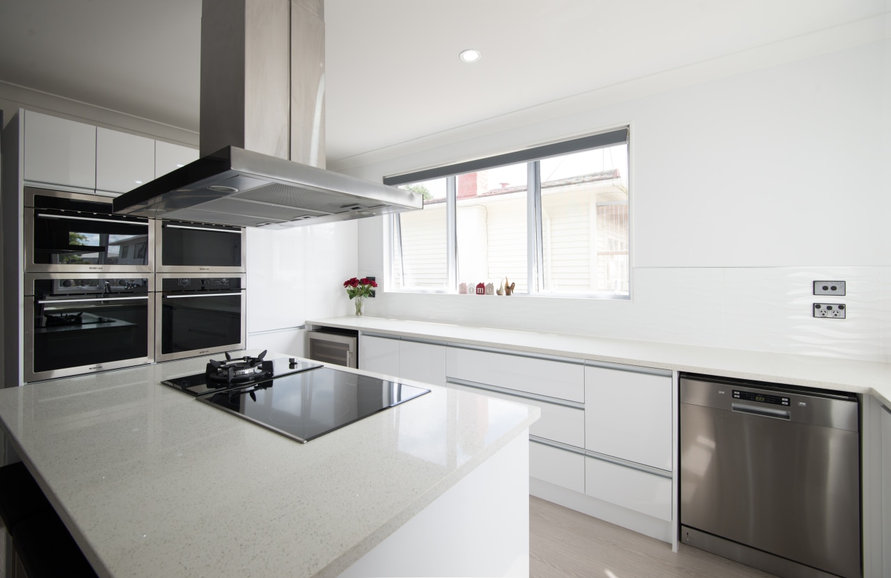 The central rangehood brings a sculptural touch to countertop, cuisine classique, interior design, kitchen, property, real estate, white