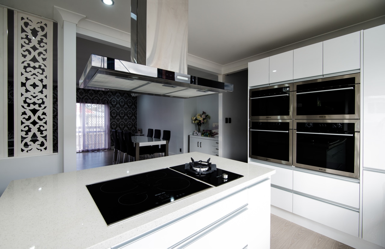 This sleek, contemporary white kitchen is designed and cabinetry, countertop, cuisine classique, home appliance, interior design, kitchen, room, gray