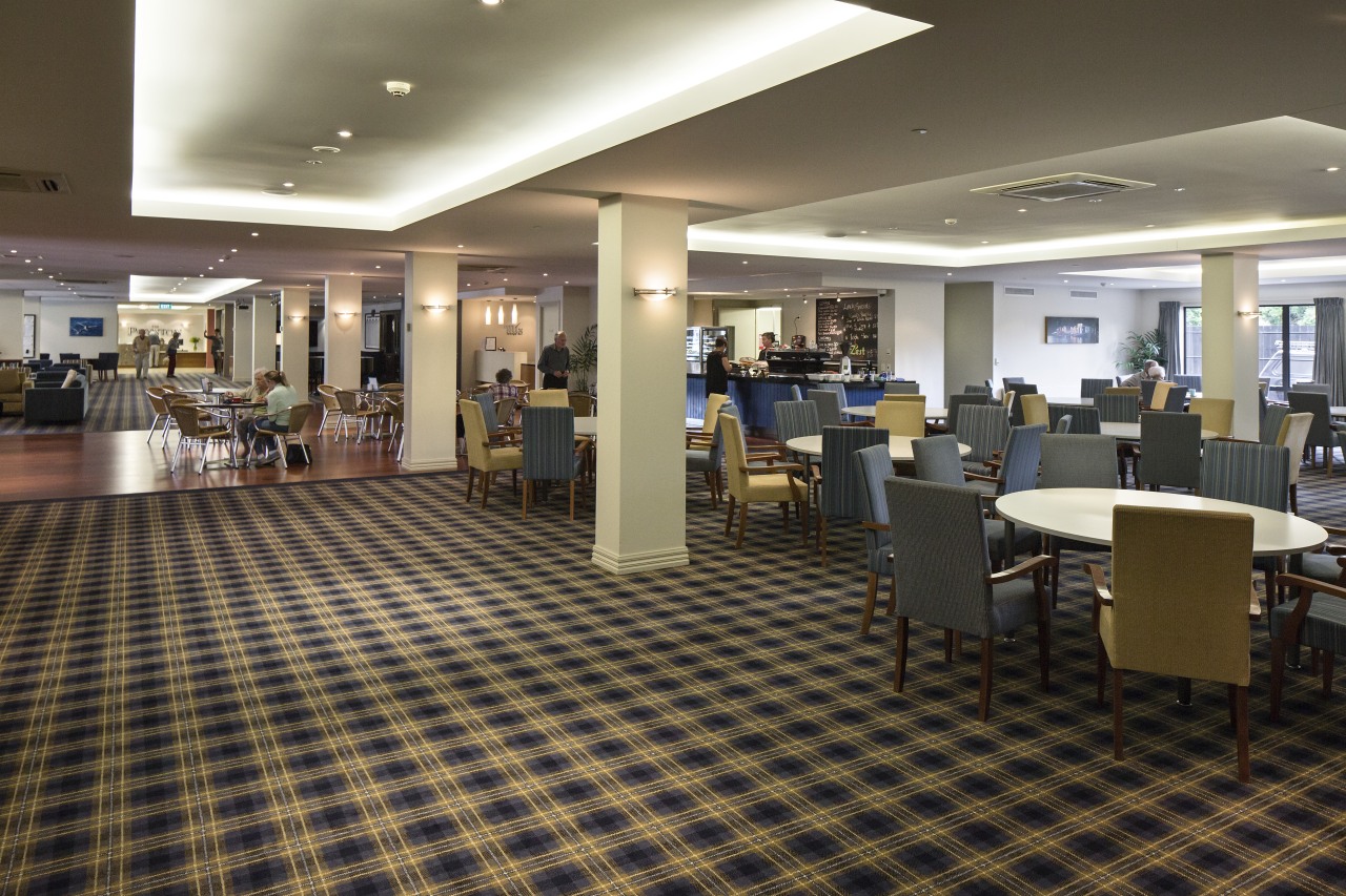 Extensive facilities at The Poynton retirement village include floor, flooring, institution, interior design, lobby, restaurant, brown