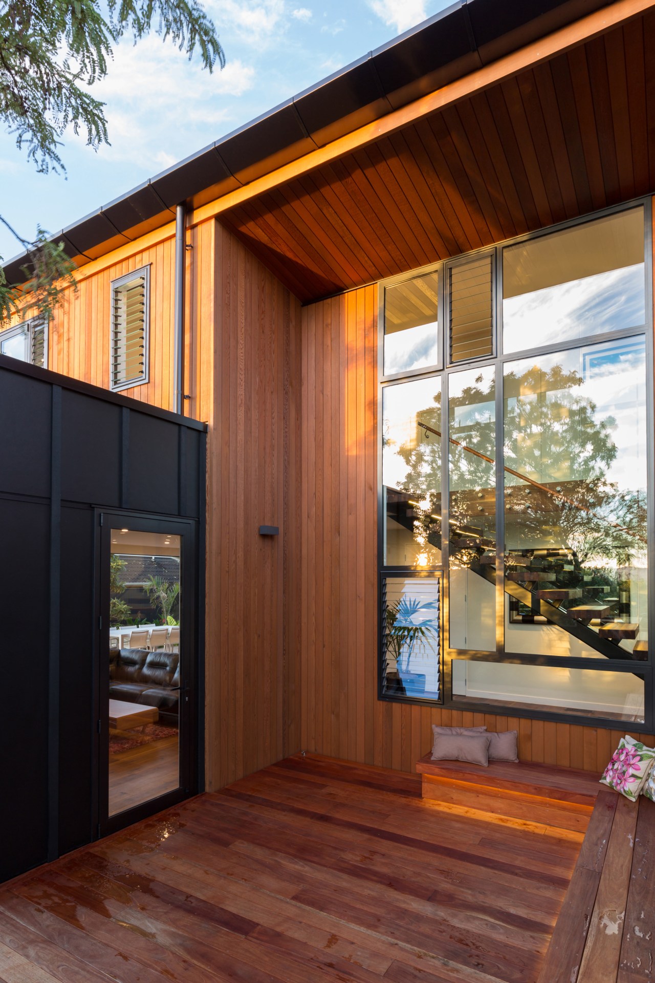 Black and tan black fibrous cement meets red architecture, deck, facade, home, house, interior design, real estate, siding, window, wood, wood stain, brown