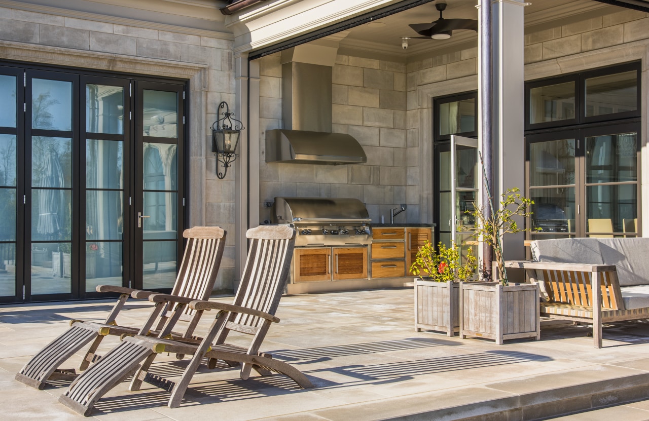 Shirley McFarlane designed this outdoor barbeque area as chair, door, furniture, interior design, outdoor structure, patio, porch, real estate, table, window