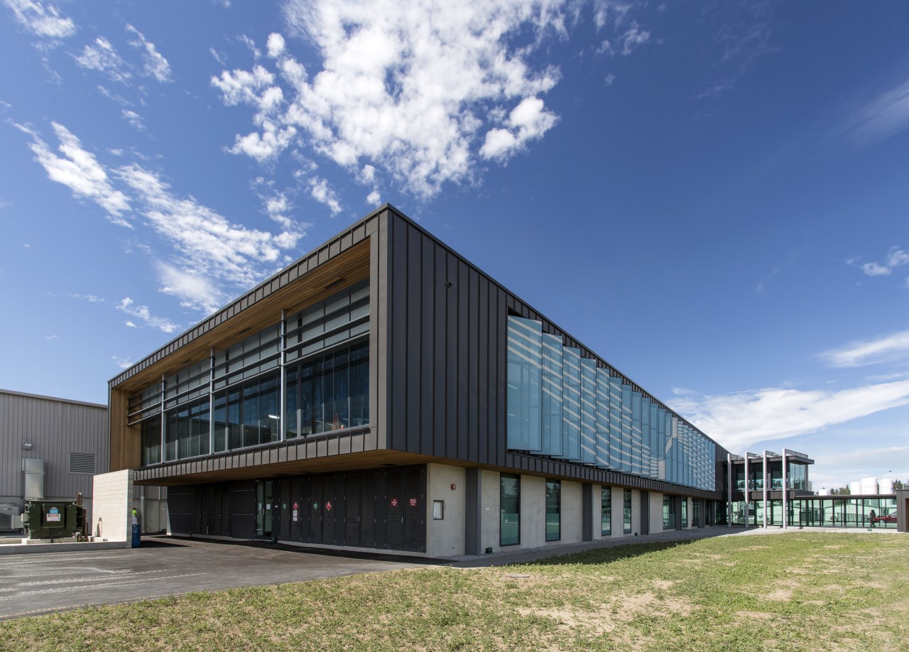 Wood soffits add a natural accent to the architecture, building, commercial building, corporate headquarters, facade, headquarters, mixed use, real estate, sky, teal